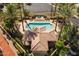 Aerial view of community pool and spa with lounge chairs, umbrellas, gazebo, and mature landscaping at 10429 N 101St St, Scottsdale, AZ 85258