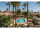 Community pool with lounge chairs, umbrellas, gazebo, palm trees, and lush landscaping at 10429 N 101St St, Scottsdale, AZ 85258