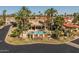 Beautiful community pool featuring a waterfall, gazebo, and lush landscaping with mature palm trees at 10429 N 101St St, Scottsdale, AZ 85258