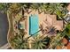 Aerial view of the community pool with spa, gazebo, lounge chairs, umbrellas, and lush landscaping at 10429 N 101St St, Scottsdale, AZ 85258