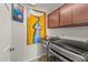 This laundry room has a modern washer and dryer, storage cabinets, and artwork at 10429 N 101St St, Scottsdale, AZ 85258