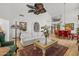 Bright living room featuring a plush sofa, hardwood floors, and an oversized ceiling fan at 10429 N 101St St, Scottsdale, AZ 85258