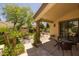 Covered patio with glass table, seating, and landscaped backyard at 10429 N 101St St, Scottsdale, AZ 85258