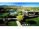 Scenic aerial view showcasing the community's swimming pool, tennis courts, and lush green spaces at 10651 E Fernwood Ln, Scottsdale, AZ 85262