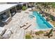 Aerial view of luxurious backyard pool with hot tub, desert landscaping, and seating area at 10651 E Fernwood Ln, Scottsdale, AZ 85262