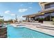 Aerial view of backyard featuring pool, hot tub, covered patio, and desert landscaping at 10651 E Fernwood Ln, Scottsdale, AZ 85262