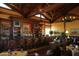Elegant bar and dining area with wooden beams, comfortable seating, and well-stocked bar for a relaxed atmosphere at 10651 E Fernwood Ln, Scottsdale, AZ 85262