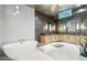 Luxury bathroom features soaking tub, double vanity, and contemporary design at 10651 E Fernwood Ln, Scottsdale, AZ 85262