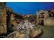 Charming courtyard with outdoor dining, stone architecture, and festive lighting at 10651 E Fernwood Ln, Scottsdale, AZ 85262