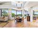 Bright dining area with floor-to-ceiling windows offering scenic views of desert landscaping and nearby pool at 10651 E Fernwood Ln, Scottsdale, AZ 85262