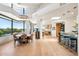 Open-concept dining area featuring hardwood floors, modern lighting, and seamless access to the outdoor pool area at 10651 E Fernwood Ln, Scottsdale, AZ 85262