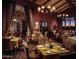 Elegant dining room featuring rich wood accents, chandeliers, and set tables at 10651 E Fernwood Ln, Scottsdale, AZ 85262