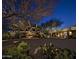 Well-lit property entrance with desert landscaping, fire pit and exterior decoration at 10651 E Fernwood Ln, Scottsdale, AZ 85262