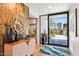 Inviting entryway with hardwood floors, desert-inspired decor, and a grand view of the home's desert landscape at 10651 E Fernwood Ln, Scottsdale, AZ 85262