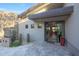 Modern entryway featuring stone accents, desert landscaping, and a glimpse of the home's open-concept interior at 10651 E Fernwood Ln, Scottsdale, AZ 85262