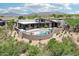 Desert home featuring backyard pool, spa, and outdoor kitchen at 10651 E Fernwood Ln, Scottsdale, AZ 85262