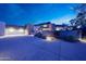 Desert home with a stone accent wall and well manicured landscaping at 10651 E Fernwood Ln, Scottsdale, AZ 85262