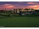 Stunning desert home at sunset with a manicured lawn and lush desert vegetation at 10651 E Fernwood Ln, Scottsdale, AZ 85262