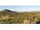 Scenic view of a golf course and rolling hills with desert vegetation in the background at 10651 E Fernwood Ln, Scottsdale, AZ 85262