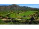 Scenic view of a lush golf course set against a backdrop of mountains and desert landscape at 10651 E Fernwood Ln, Scottsdale, AZ 85262