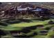 Aerial view of the golf course with lush green fairways, sand traps, and a scenic landscape at 10651 E Fernwood Ln, Scottsdale, AZ 85262