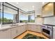 Bright kitchen features large windows with views, stainless steel appliances, and modern finishes at 10651 E Fernwood Ln, Scottsdale, AZ 85262