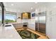 Well-lit kitchen featuring stainless steel appliances, white countertops, stylish cabinets, and a kitchen island at 10651 E Fernwood Ln, Scottsdale, AZ 85262