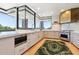 Modern kitchen with white counters, stainless steel appliances, kitchen island, and floor-to-ceiling windows at 10651 E Fernwood Ln, Scottsdale, AZ 85262