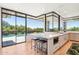 Open kitchen flows to outdoor pool, featuring an island with stool seating at 10651 E Fernwood Ln, Scottsdale, AZ 85262