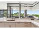 Open kitchen with island, stainless appliances, light countertops, and scenic desert view at 10651 E Fernwood Ln, Scottsdale, AZ 85262