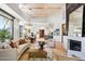 Spacious open-plan living space with hardwood floors, fireplace, and stylish decor at 10651 E Fernwood Ln, Scottsdale, AZ 85262