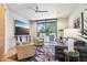 Inviting living room boasts a ceiling fan, comfortable seating, and sliding glass door to the outside at 10651 E Fernwood Ln, Scottsdale, AZ 85262