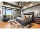 Relaxing main bedroom with outdoor access, ceiling fan, and a king bed at 10651 E Fernwood Ln, Scottsdale, AZ 85262