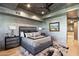 Well-decorated main bedroom with king bed, ceiling fan, lamps, and a painting at 10651 E Fernwood Ln, Scottsdale, AZ 85262