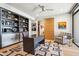 Stylish office features built-in shelving, a modern desk, an accent rug, and a comfortable chair at 10651 E Fernwood Ln, Scottsdale, AZ 85262