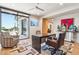 Well-lit office with a large desk, comfortable seating, and views of the pool at 10651 E Fernwood Ln, Scottsdale, AZ 85262