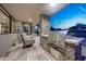 Outdoor patio area featuring a stone grill, bar and comfortable seating at 10651 E Fernwood Ln, Scottsdale, AZ 85262