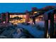 Stunning outdoor patio area with stone accents, comfortable seating, and sunset views at 10651 E Fernwood Ln, Scottsdale, AZ 85262