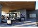 Outdoor terrace with ample seating, dining areas, and television screens, ideal for gatherings and enjoying sports at 10651 E Fernwood Ln, Scottsdale, AZ 85262
