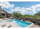 Relaxing backyard pool and hot tub area with water features and desert landscaping at 10651 E Fernwood Ln, Scottsdale, AZ 85262