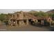 Charming stone gatehouse with red tile roof and mature desert landscaping at 10651 E Fernwood Ln, Scottsdale, AZ 85262