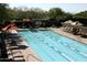 Outdoor swimming pool with multiple lanes, sun loungers, and umbrellas for relaxing poolside at 10651 E Fernwood Ln, Scottsdale, AZ 85262