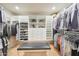 Organized walk-in closet features custom shelving, drawers, and ample hanging space at 10651 E Fernwood Ln, Scottsdale, AZ 85262