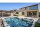 Inviting backyard features a sparkling pool, covered patio, and lush landscaping, perfect for relaxation and outdoor entertaining at 10925 E Toluca Ave, Mesa, AZ 85212