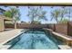 Beautiful pool reflects the sky, surrounded by a paved patio and privacy fence for a serene outdoor experience at 10925 E Toluca Ave, Mesa, AZ 85212