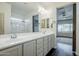 Bright bathroom featuring a glass shower and double vanity with modern fixtures at 10925 E Toluca Ave, Mesa, AZ 85212