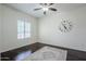 Bedroom with ceiling fan, window, and hardwood flooring at 10925 E Toluca Ave, Mesa, AZ 85212