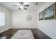 Bedroom with ceiling fan, window, and hardwood flooring at 10925 E Toluca Ave, Mesa, AZ 85212