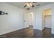 This bedroom features a ceiling fan, an adjacent closet, and modern vinyl plank flooring at 10925 E Toluca Ave, Mesa, AZ 85212