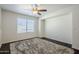 Bright bedroom features a ceiling fan, hardwood floors, a window, and crisp white walls at 10925 E Toluca Ave, Mesa, AZ 85212